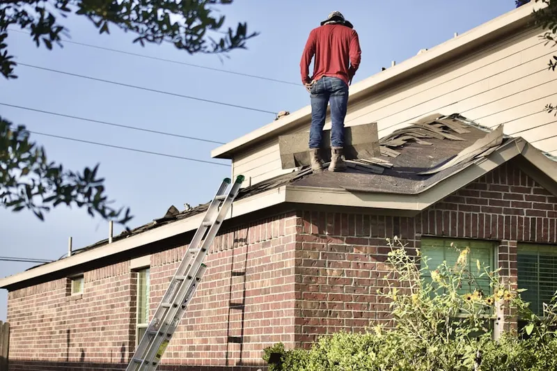 Professional roofer working on a residential roof in Belle Mead